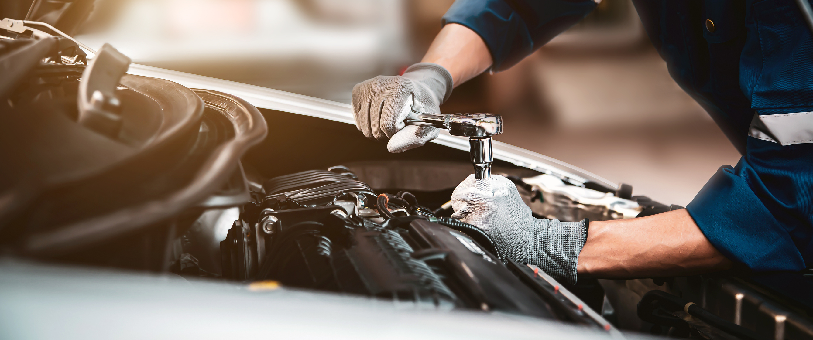 Technician servicing a vehicle engine at HiWay Auto Collision Center